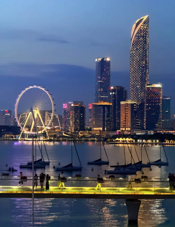 Jinji Lake at night: the lit skyline, ferris wheel and the Gate of the Orient tower seen from the waterfront