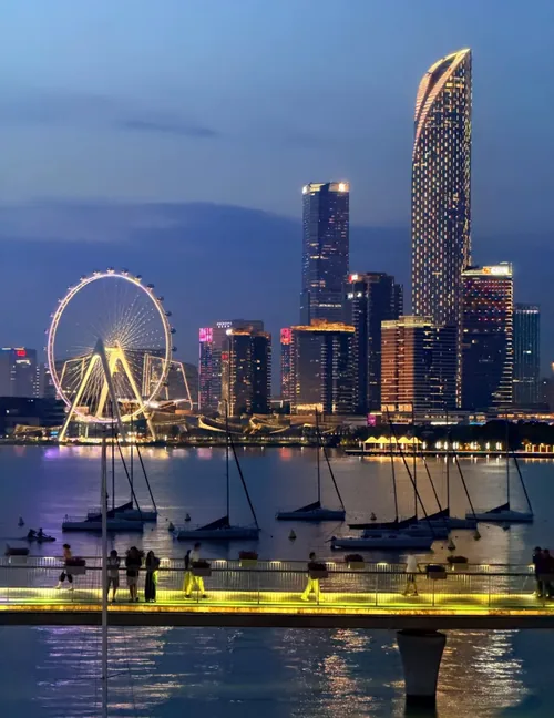 Jinji Lake at night: the lit skyline, ferris wheel and the Gate of the Orient tower seen from the waterfront