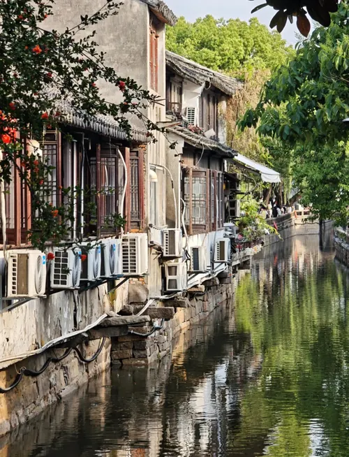 Pingjiang Road's quiet canal with white-walled houses along the water