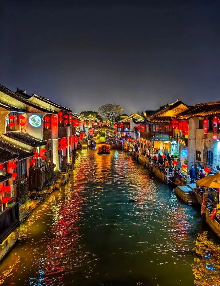 Shantang Street at night: red lanterns reflected in the canal